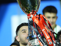 Theo Hernandez left-back of AC Milan and France lifts the trophy after winning with his team the EA SPORTS FC SUPERCUP 24/25 final match bet...