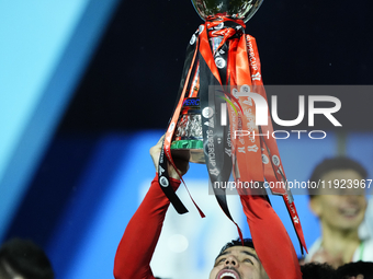 Theo Hernandez left-back of AC Milan and France lifts the trophy after winning with his team the EA SPORTS FC SUPERCUP 24/25 final match bet...