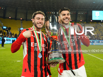 Davide Calabria right-back of AC Milan and Italy and Theo Hernandez left-back of AC Milan and France celebrate with the trophy after winning...