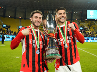 Davide Calabria right-back of AC Milan and Italy and Theo Hernandez left-back of AC Milan and France celebrate with the trophy after winning...