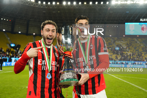 Davide Calabria right-back of AC Milan and Italy and Theo Hernandez left-back of AC Milan and France celebrate with the trophy after winning...