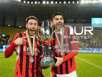 Davide Calabria right-back of AC Milan and Italy and Theo Hernandez left-back of AC Milan and France celebrate with the trophy after winning...