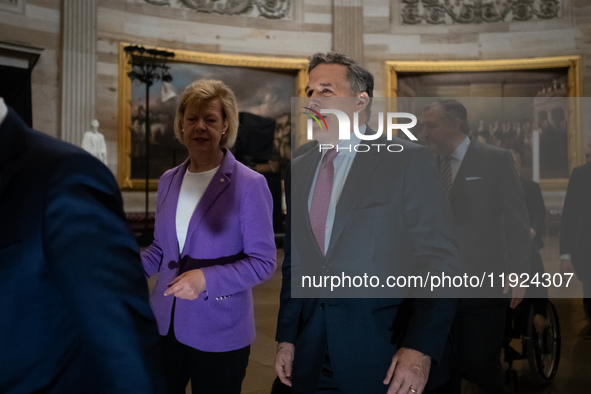 Newly elected Senator DAve McCormick (R-PA) (center right) talks with Senator Tina Smith (D-MN) en route to the House of Representatives for...