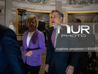 Newly elected Senator DAve McCormick (R-PA) (center right) talks with Senator Tina Smith (D-MN) en route to the House of Representatives for...