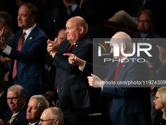 Rep. Mike Kelly (R-PA) (right) and other Republicans applaud the reading of electoral votes for Trump during a joint session of Congress cer...