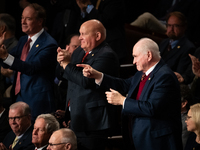 Rep. Mike Kelly (R-PA) (right) and other Republicans applaud the reading of electoral votes for Trump during a joint session of Congress cer...