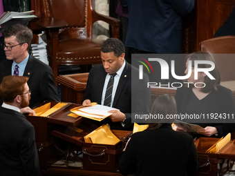 House floor staff distribute electoral vote certificates following the conclusion of a joint session of Congress certifying the results of t...