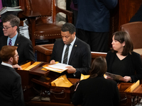 House floor staff distribute electoral vote certificates following the conclusion of a joint session of Congress certifying the results of t...