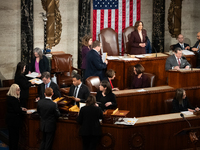 House floor staff (bottom left) distribute electoral vote certificates while Vice President Kamala Harris presides over a joint session of C...