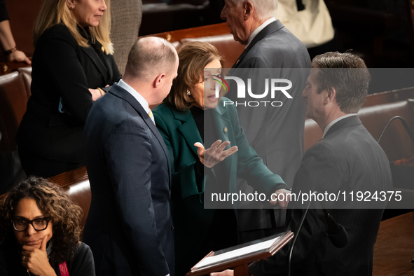 House Speaker Emerita Nancy Pelosi (D-CA) speaks with aides following the conclusion of a joint session of Congress certifying the results o...