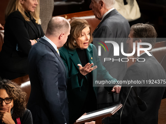 House Speaker Emerita Nancy Pelosi (D-CA) speaks with aides following the conclusion of a joint session of Congress certifying the results o...