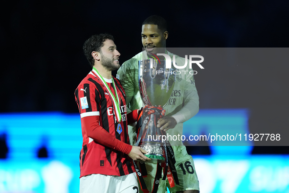 Davide Calabria right-back of AC Milan and Italy and Mike Maignan goalkeeper of AC Milan and France celebrate with the trophy after winning...