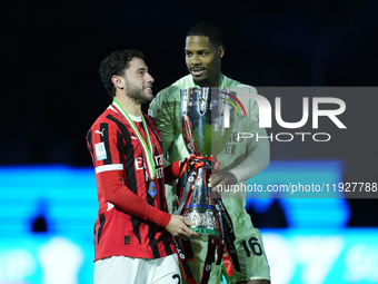 Davide Calabria right-back of AC Milan and Italy and Mike Maignan goalkeeper of AC Milan and France celebrate with the trophy after winning...