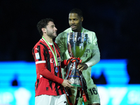 Davide Calabria right-back of AC Milan and Italy and Mike Maignan goalkeeper of AC Milan and France celebrate with the trophy after winning...