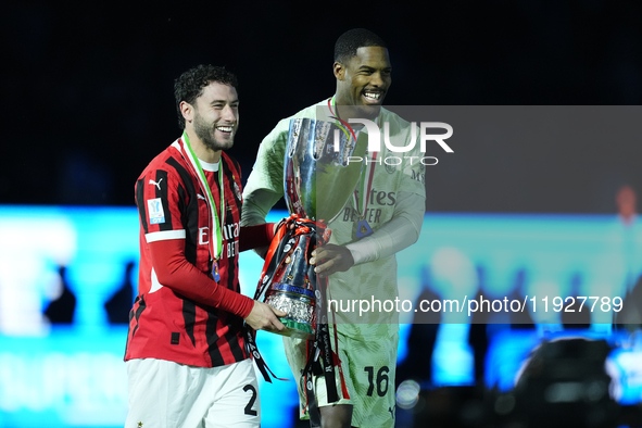 Davide Calabria right-back of AC Milan and Italy and Mike Maignan goalkeeper of AC Milan and France celebrate with the trophy after winning...