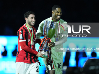 Davide Calabria right-back of AC Milan and Italy and Mike Maignan goalkeeper of AC Milan and France celebrate with the trophy after winning...