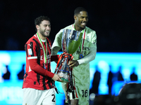 Davide Calabria right-back of AC Milan and Italy and Mike Maignan goalkeeper of AC Milan and France celebrate with the trophy after winning...