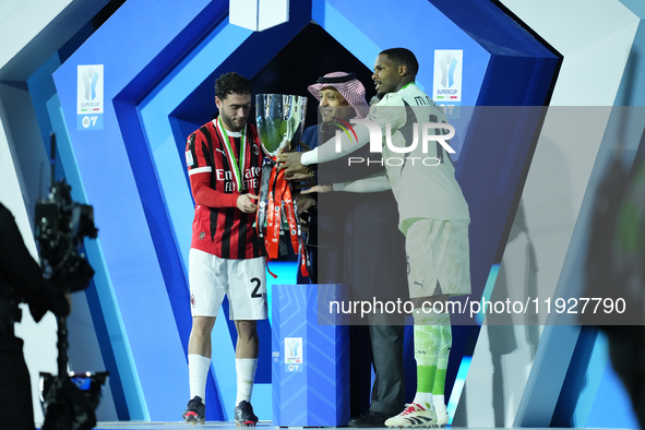 Davide Calabria right-back of AC Milan and Italy and Mike Maignan goalkeeper of AC Milan and France celebrate with the trophy after winning...