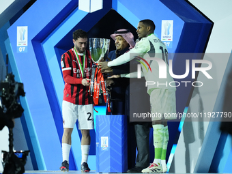 Davide Calabria right-back of AC Milan and Italy and Mike Maignan goalkeeper of AC Milan and France celebrate with the trophy after winning...