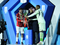 Davide Calabria right-back of AC Milan and Italy and Mike Maignan goalkeeper of AC Milan and France celebrate with the trophy after winning...