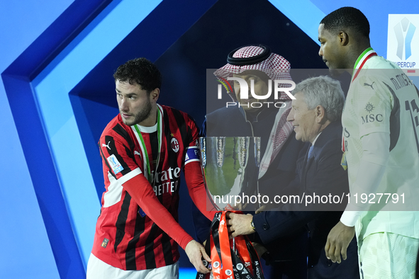 Davide Calabria right-back of AC Milan and Italy and Mike Maignan goalkeeper of AC Milan and France celebrate with the trophy after winning...