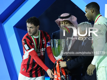 Davide Calabria right-back of AC Milan and Italy and Mike Maignan goalkeeper of AC Milan and France celebrate with the trophy after winning...