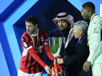 Davide Calabria right-back of AC Milan and Italy and Mike Maignan goalkeeper of AC Milan and France celebrate with the trophy after winning...