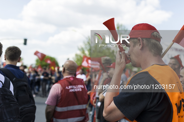 Employees of the Dailmer have gathered for a warning strike rally in front of the entrance to the company's plant in Berlin, Germany, 11 May...