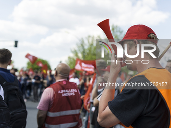 Employees of the Dailmer have gathered for a warning strike rally in front of the entrance to the company's plant in Berlin, Germany, 11 May...