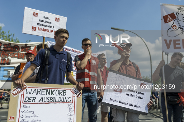 Employees of the Dailmer have gathered for a warning strike rally in front of the entrance to the company's plant in Berlin, Germany, 11 May...