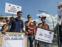 Employees of the Dailmer have gathered for a warning strike rally in front of the entrance to the company's plant in Berlin, Germany, 11 May...