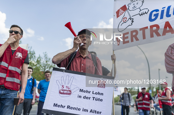 Employees of the Dailmer have gathered for a warning strike rally in front of the entrance to the company's plant in Berlin, Germany, 11 May...