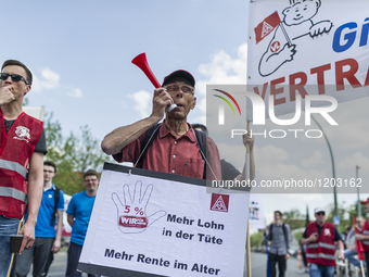 Employees of the Dailmer have gathered for a warning strike rally in front of the entrance to the company's plant in Berlin, Germany, 11 May...