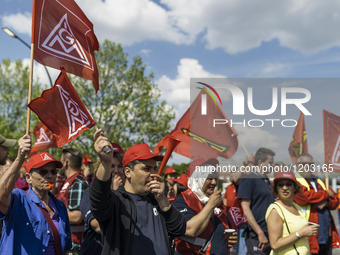 Employees of the Dailmer have gathered for a warning strike rally in front of the entrance to the company's plant in Berlin, Germany, 11 May...