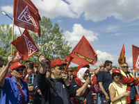 Employees of the Dailmer have gathered for a warning strike rally in front of the entrance to the company's plant in Berlin, Germany, 11 May...