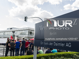 Employees of the Dailmer have gathered for a warning strike rally in front of the entrance to the company's plant in Berlin, Germany, 11 May...