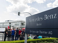 Employees of the Dailmer have gathered for a warning strike rally in front of the entrance to the company's plant in Berlin, Germany, 11 May...