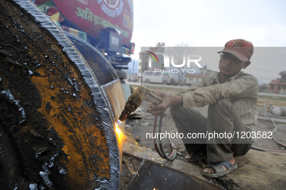 SUDHIR KUMAR PATEL, 28 yrs old, migrated from India Cutting heavy duty roller's Metal with Oxygen Acetylene Gas as Spark splash around the g...