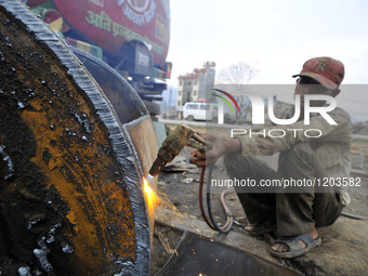 SUDHIR KUMAR PATEL, 28 yrs old, migrated from India Cutting heavy duty roller's Metal with Oxygen Acetylene Gas as Spark splash around the g...