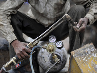 SUDHIR KUMAR PATEL, 28 yrs old, migrated from India checks Oxygen gas after changing cylinder to cut heavy duty roller with Oxygen Acetylene...