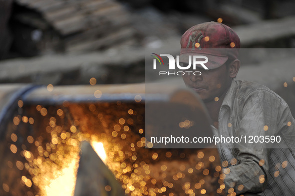 SUDHIR KUMAR PATEL, 28 yrs old, migrated from India Cutting heavy duty roller's Metal with Oxygen Acetylene Gas as Spark splash around the g...