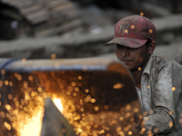 SUDHIR KUMAR PATEL, 28 yrs old, migrated from India Cutting heavy duty roller's Metal with Oxygen Acetylene Gas as Spark splash around the g...