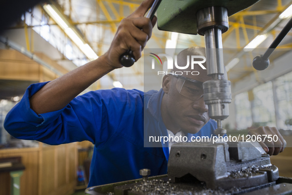 Fitting and Turning Trade of the Windhoek Vocational Training Centre, Namibia, on May 12, 2016. Student works with a drill machine making ho...