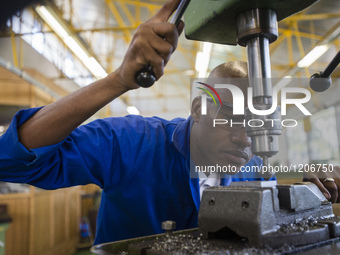 Fitting and Turning Trade of the Windhoek Vocational Training Centre, Namibia, on May 12, 2016. Student works with a drill machine making ho...