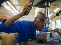 Fitting and Turning Trade of the Windhoek Vocational Training Centre, Namibia, on May 12, 2016. Student works with a drill machine making ho...