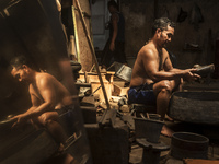 A worker checking gamelan in Gamelan Daliyo Legiyono, Pelem Lor Batu Retno Village, Banguntapan, Yogyakarta, Indonesia, on May 13, 2016. Gam...