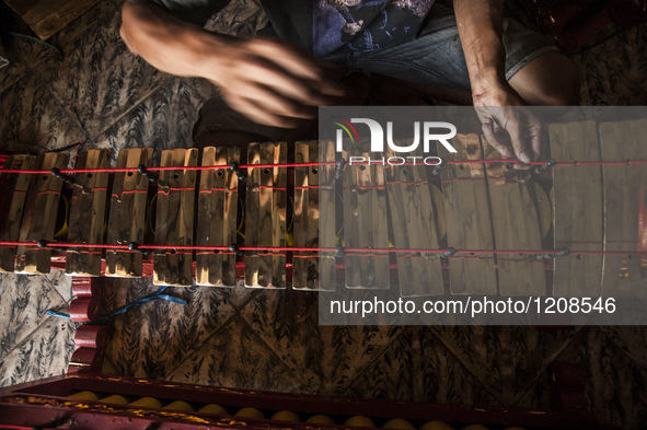 A worker checking gendher penerus in Gamelan Daliyo Legiyono, Pelem Lor Batu Retno Village, Banguntapan, Yogyakarta, Indonesia, on May 13, 2...