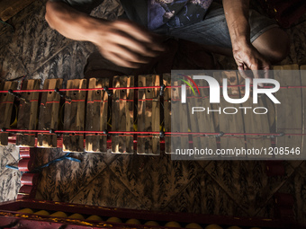 A worker checking gendher penerus in Gamelan Daliyo Legiyono, Pelem Lor Batu Retno Village, Banguntapan, Yogyakarta, Indonesia, on May 13, 2...