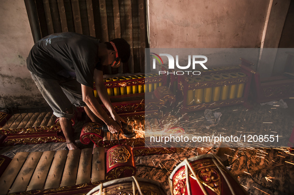 A worker welding gendher penerus in Gamelan Daliyo Legiyono, Pelem Lor Batu Retno Village, Banguntapan, Yogyakarta, Indonesia, on May 13, 20...