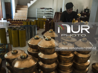 A worker checking gendher penerus in Gamelan Daliyo Legiyono, Pelem Lor Batu Retno Village, Banguntapan, Yogyakarta, Indonesia, on May 13, 2...